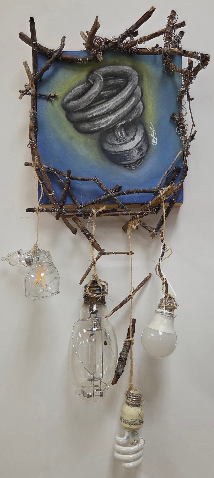 Mixed-media hanging installation incorporating multiple light bulbs and sticks.